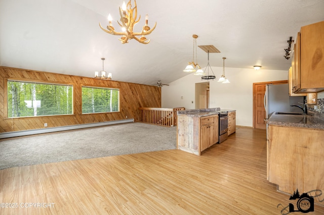 4800 W Lucy Lake Rd, Wasilla, AK 99623 - kitchen featuring appliances with stainless steel finishes, a chandelier, a sink, vaulted ceiling, and wood walls