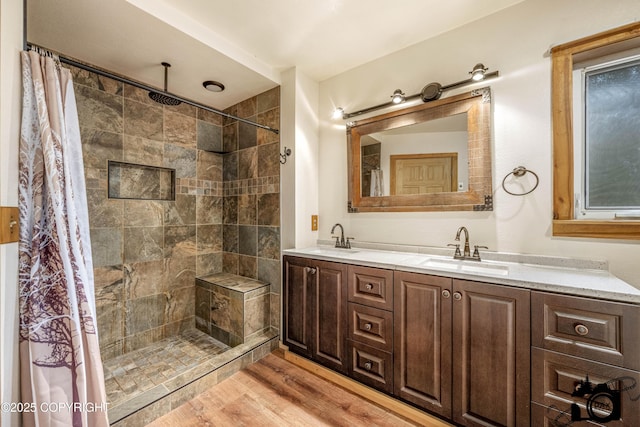 4800 W Lucy Lake Rd, Wasilla, AK 99623 - full bathroom with double vanity, wood finished floors, and tiled shower