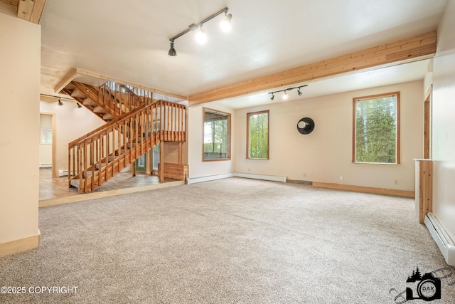 4800 W Lucy Lake Rd, Wasilla, AK 99623 - unfurnished living room with rail lighting, stairway, healthy amount of natural light, and carpet flooring