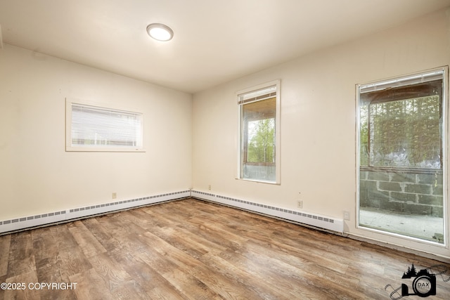 4800 W Lucy Lake Rd, Wasilla, AK 99623 - unfurnished room featuring wood finished floors and a baseboard heating unit