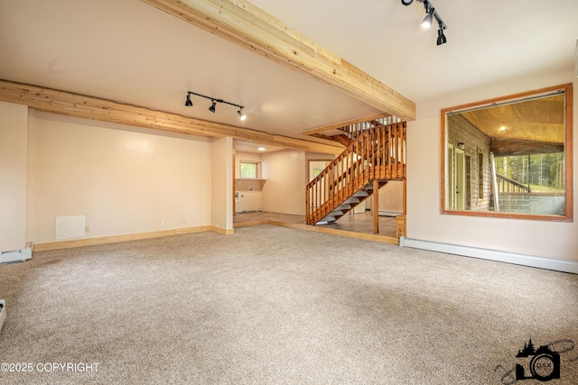 4800 W Lucy Lake Rd, Wasilla, AK 99623 - unfurnished living room featuring track lighting, stairway, carpet, a baseboard radiator, and baseboards