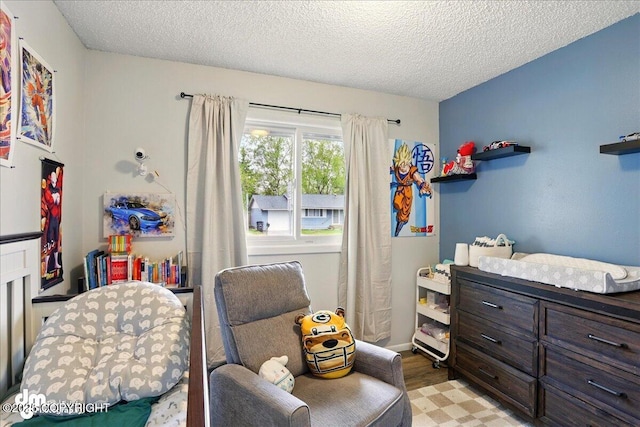 bedroom with a textured ceiling and light wood-type flooring