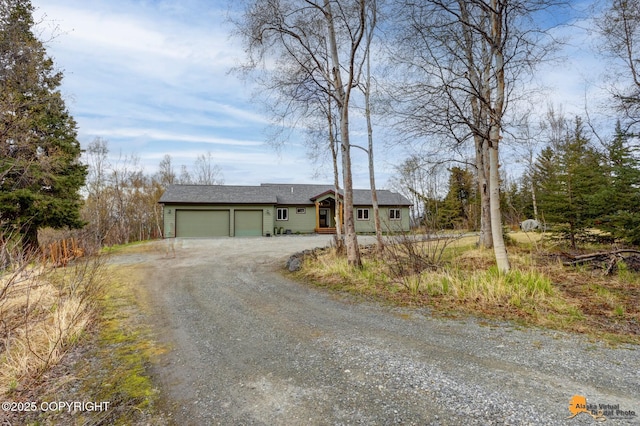 ranch-style home with driveway and an attached garage