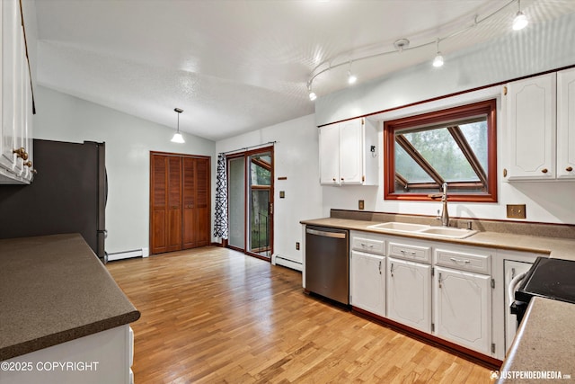 kitchen with stainless steel appliances, a sink, a baseboard radiator, white cabinets, and vaulted ceiling