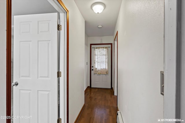 hall featuring dark wood finished floors and baseboards