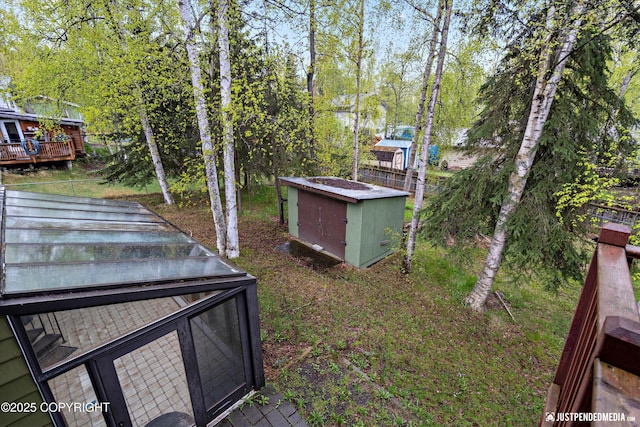 view of yard featuring view of scattered trees and a wooden deck