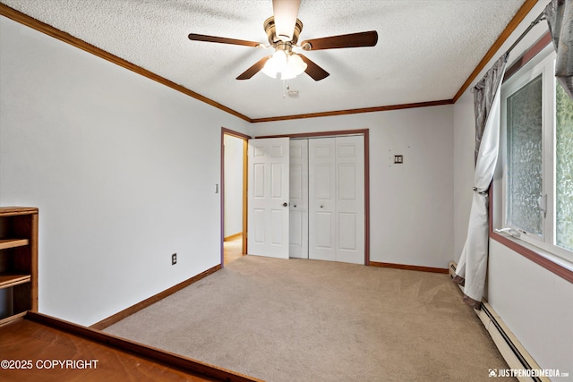 unfurnished bedroom featuring a baseboard radiator, a closet, crown molding, a textured ceiling, and carpet flooring