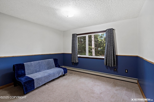 unfurnished room featuring carpet floors, a baseboard radiator, a textured ceiling, and baseboards