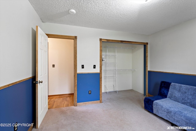 unfurnished room with carpet flooring and a textured ceiling