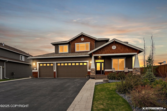 4187 Chiniak Bay Dr, Anchorage, AK 99515 - view of front of house with asphalt driveway, a garage, fence, covered porch, and stone siding