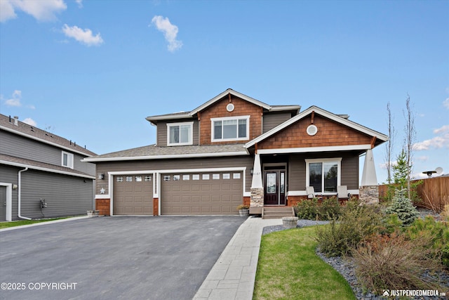 4187 Chiniak Bay Dr, Anchorage, AK 99515 - craftsman-style home featuring a garage, asphalt driveway, fence, and covered porch