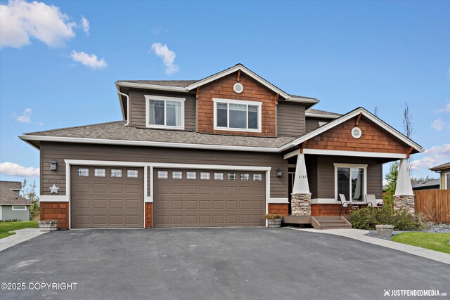 4187 Chiniak Bay Dr, Anchorage, AK 99515 - craftsman-style home with an attached garage, driveway, covered porch, and roof with shingles