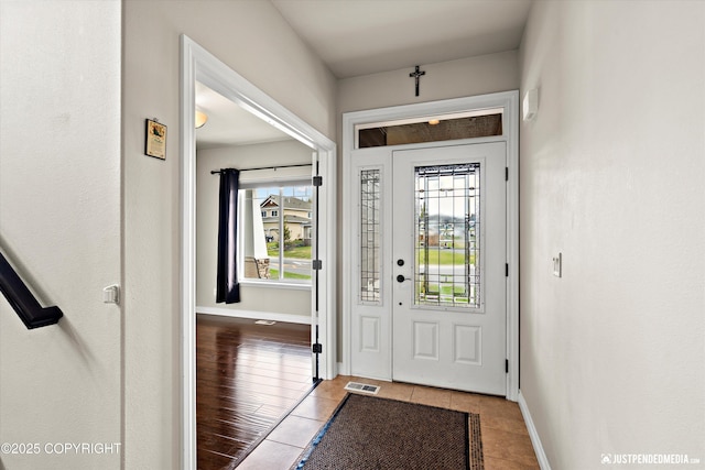 4187 Chiniak Bay Dr, Anchorage, AK 99515 - foyer entrance featuring healthy amount of natural light, tile patterned floors, and baseboards