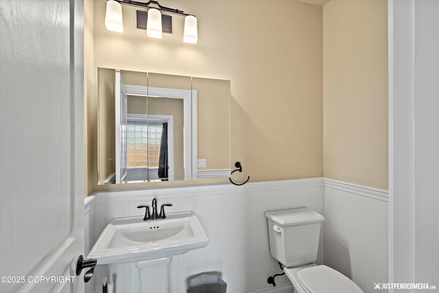 4187 Chiniak Bay Dr, Anchorage, AK 99515 - half bath with wainscoting, toilet, and a sink