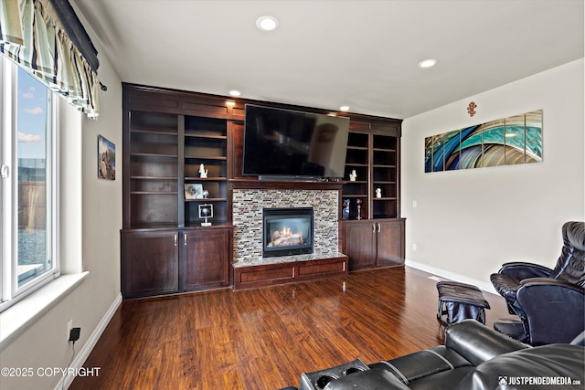 4187 Chiniak Bay Dr, Anchorage, AK 99515 - living room featuring baseboards, dark wood-style floors, recessed lighting, a tiled fireplace, and built in features