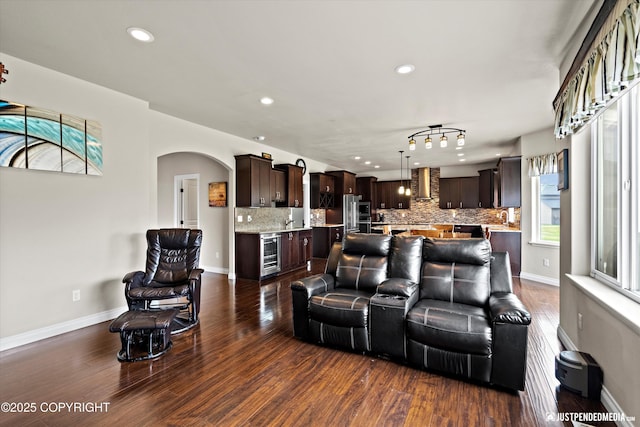 4187 Chiniak Bay Dr, Anchorage, AK 99515 - living room with wine cooler, dark wood finished floors, recessed lighting, arched walkways, and baseboards