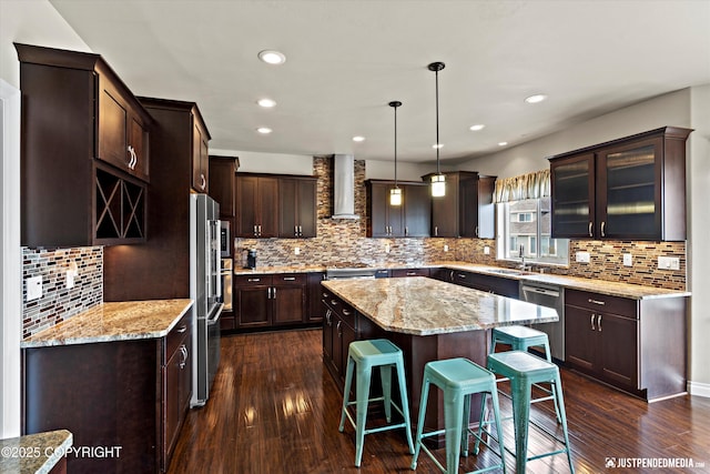 4187 Chiniak Bay Dr, Anchorage, AK 99515 - kitchen featuring wall chimney range hood, dishwasher, a center island, a sink, and dark brown cabinets