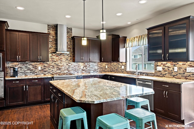 4187 Chiniak Bay Dr, Anchorage, AK 99515 - kitchen featuring wall chimney exhaust hood, dark wood finished floors, a kitchen bar, dark brown cabinets, and recessed lighting
