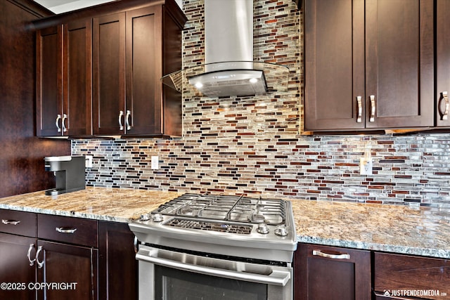 4187 Chiniak Bay Dr, Anchorage, AK 99515 - kitchen with wall chimney exhaust hood, stainless steel gas range oven, dark brown cabinetry, and tasteful backsplash