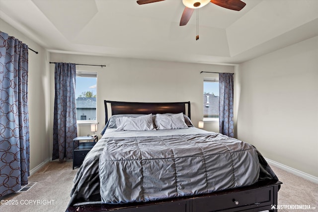 4187 Chiniak Bay Dr, Anchorage, AK 99515 - bedroom featuring a tray ceiling, light colored carpet, and baseboards