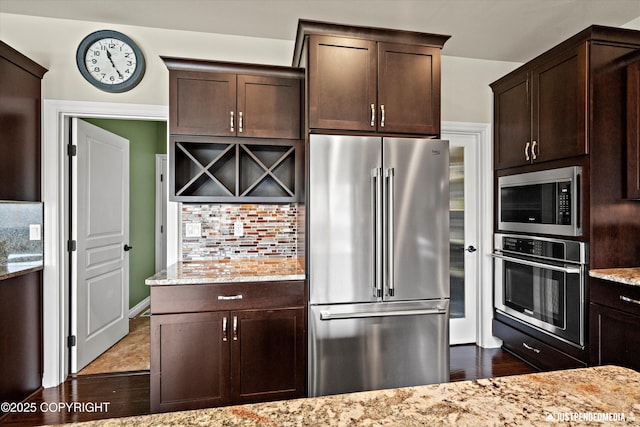 4187 Chiniak Bay Dr, Anchorage, AK 99515 - kitchen with stainless steel appliances, backsplash, dark brown cabinets, and dark wood-style flooring