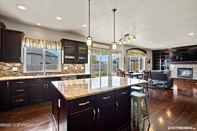 4187 Chiniak Bay Dr, Anchorage, AK 99515 - kitchen with a sink, dark wood-style flooring, a breakfast bar area, tasteful backsplash, and recessed lighting