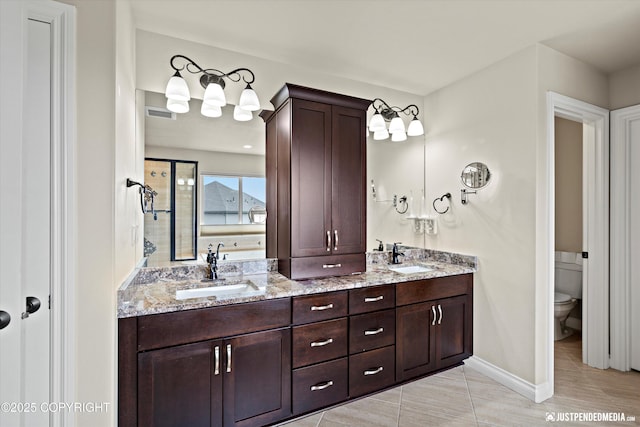 4187 Chiniak Bay Dr, Anchorage, AK 99515 - bathroom with toilet, double vanity, and baseboards