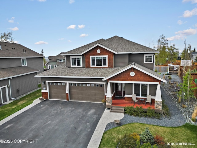 4187 Chiniak Bay Dr, Anchorage, AK 99515 - craftsman house featuring a porch, a shingled roof, asphalt driveway, an attached garage, and a front yard
