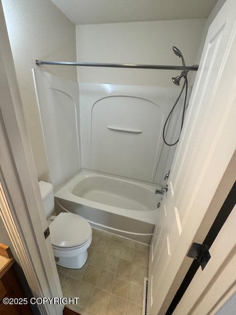 bathroom featuring toilet and shower / bath combination
