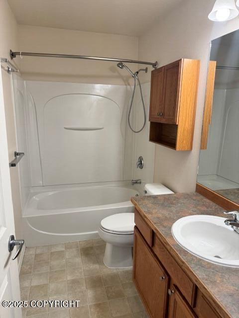 full bath featuring toilet, vanity, and  shower combination