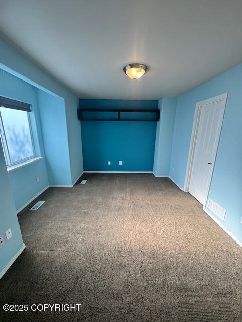 unfurnished bedroom with carpet and baseboards