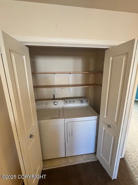 clothes washing area featuring washer and dryer and dark colored carpet
