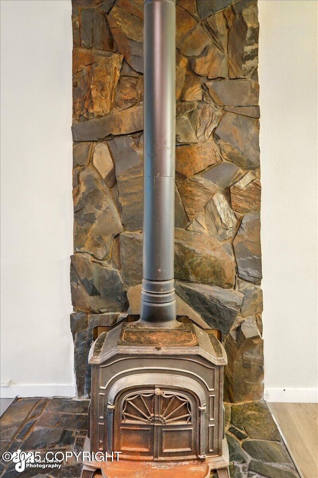 2411 N Friar Tuck Ct, Big Lake, AK 99623 - detailed view of a wood stove and baseboards