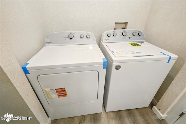 2411 N Friar Tuck Ct, Big Lake, AK 99623 - laundry room with washer and clothes dryer, light wood-style floors, and a textured wall