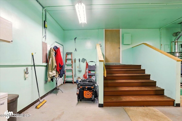 stairs featuring concrete floors