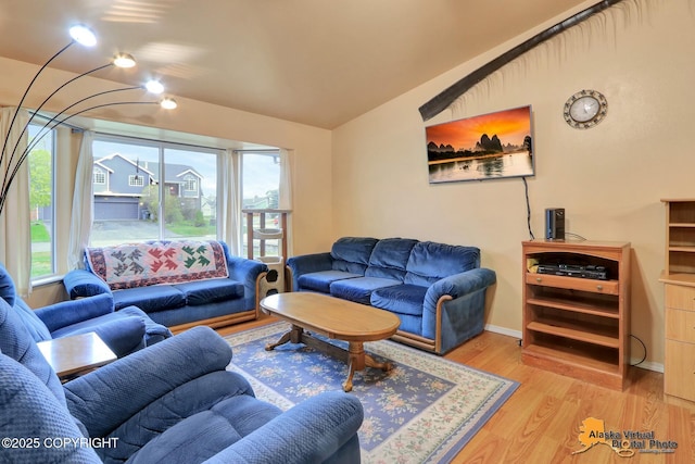 9500 Aphrodite Dr, Anchorage, AK 99515 - living room with plenty of natural light, vaulted ceiling, wood finished floors, and baseboards