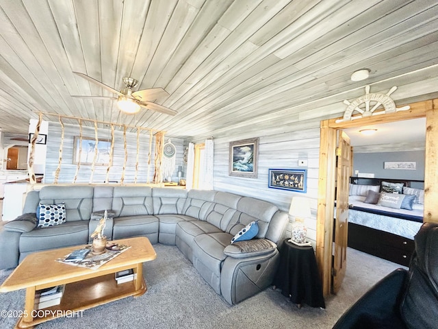 living room featuring a ceiling fan, carpet floors, and wooden ceiling