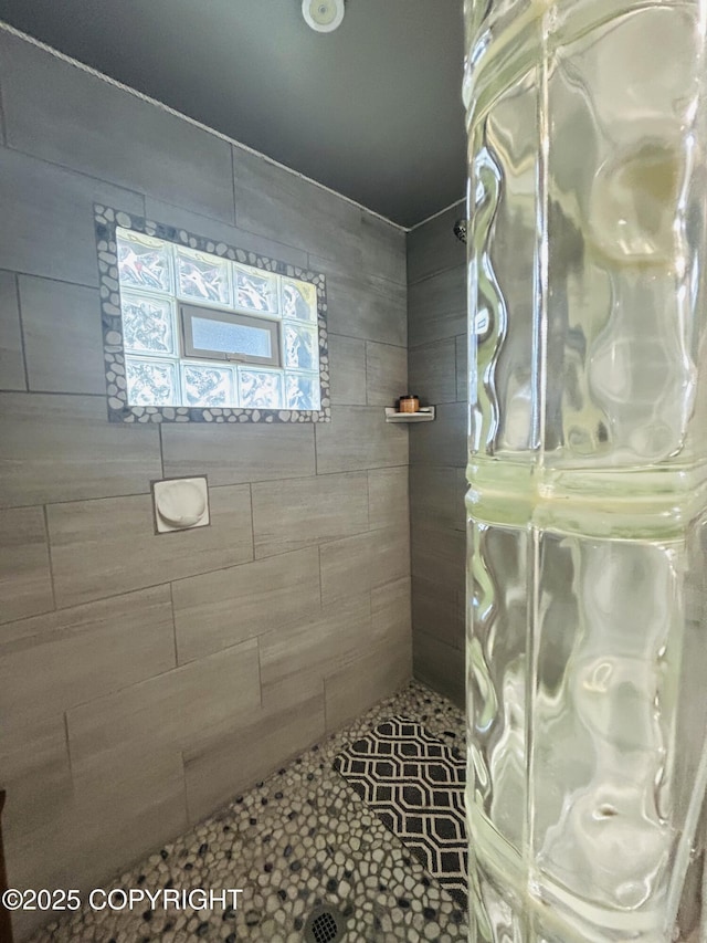 bathroom with tiled shower