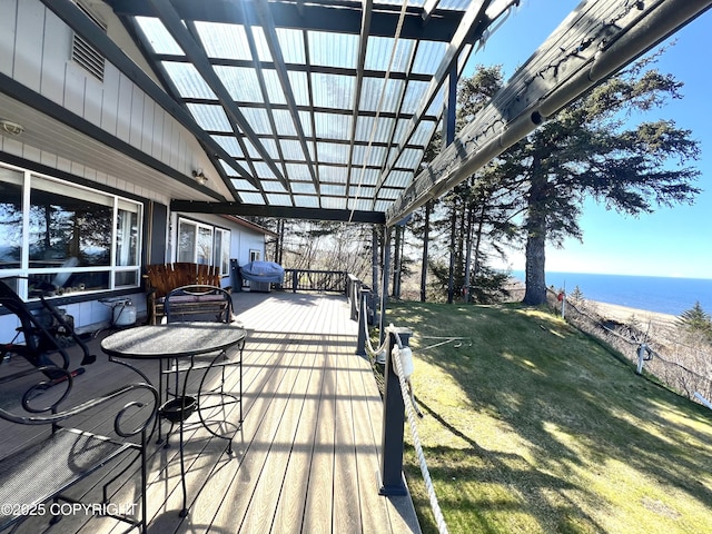 wooden deck with a water view and a yard