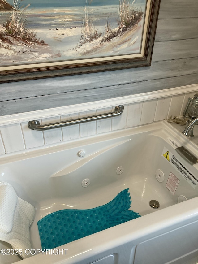 full bathroom featuring a tub with jets
