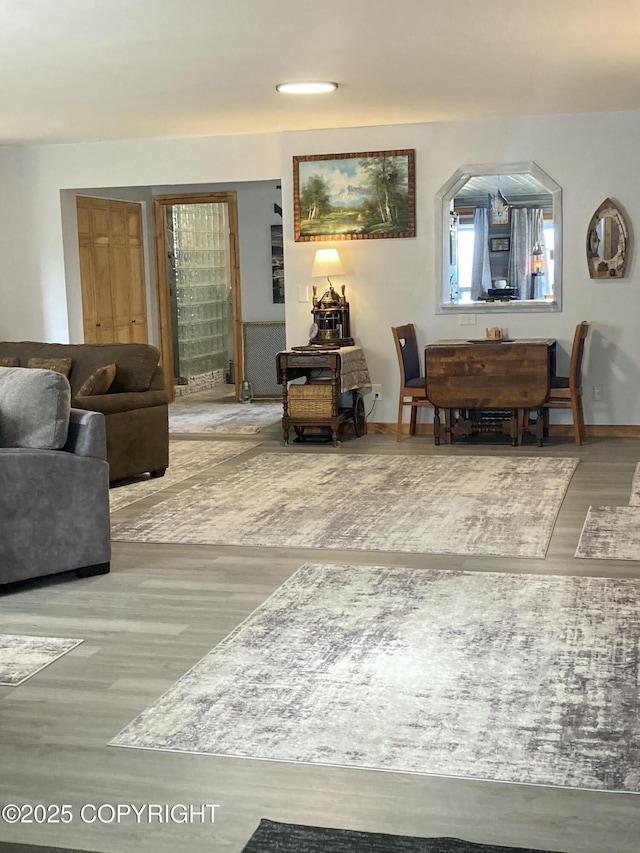 living area featuring wood finished floors and baseboards