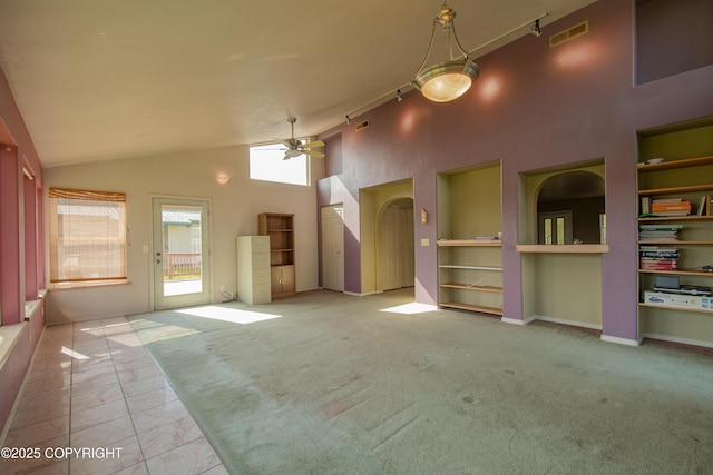 255 Lee Dr, Homer, AK 99603 - unfurnished living room featuring ceiling fan, high vaulted ceiling, carpet flooring, and arched walkways