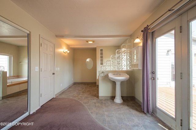 255 Lee Dr, Homer, AK 99603 - hallway featuring baseboards, stone finish floors, and a sink