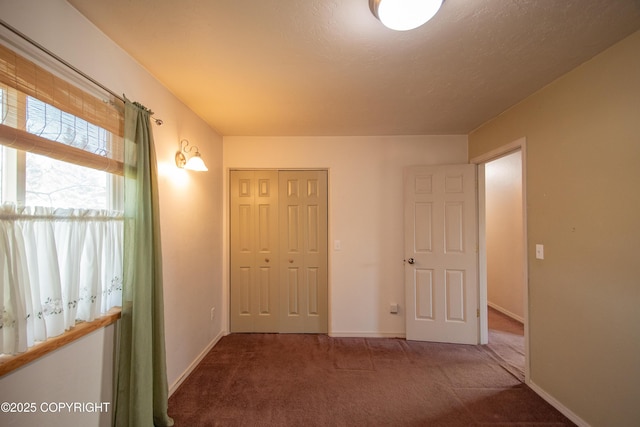 255 Lee Dr, Homer, AK 99603 - unfurnished bedroom featuring carpet flooring, a closet, and baseboards