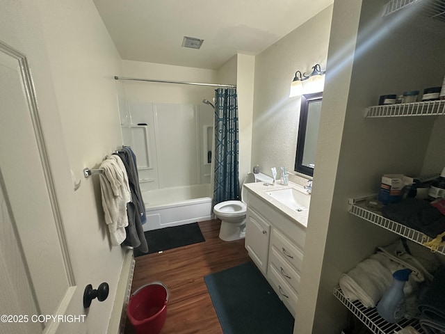full bath with wood finished floors, vanity, shower / bath combo with shower curtain, and toilet