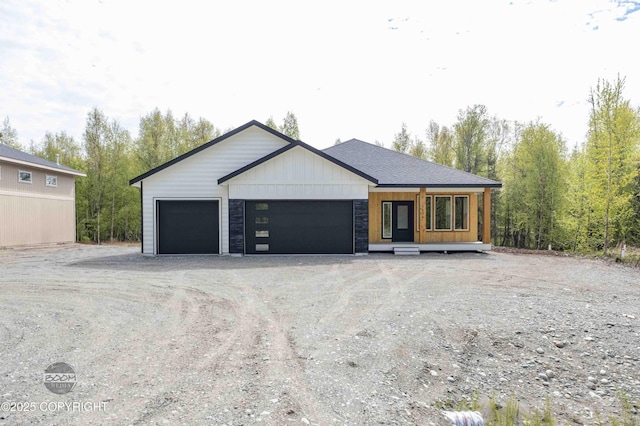 7254 E Riparian Loop, Palmer, AK 99645 - view of front of property featuring dirt driveway and a garage