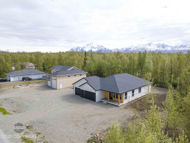 7254 E Riparian Loop, Palmer, AK 99645 - aerial view of property and surrounding area featuring a heavily wooded area and a mountainous background