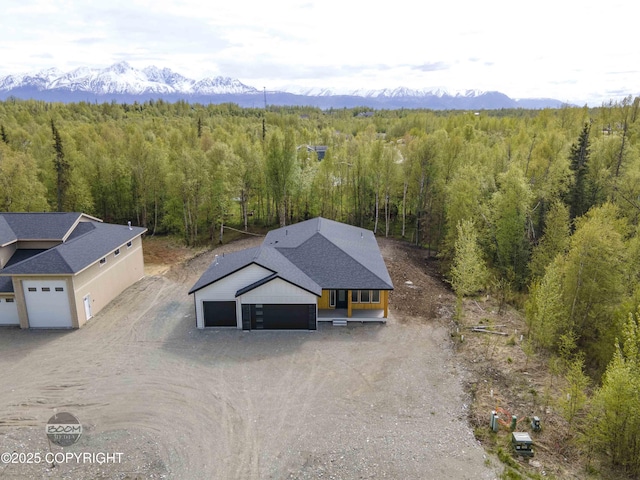 7254 E Riparian Loop, Palmer, AK 99645 - aerial view of property and surrounding area featuring a forest and a mountain backdrop