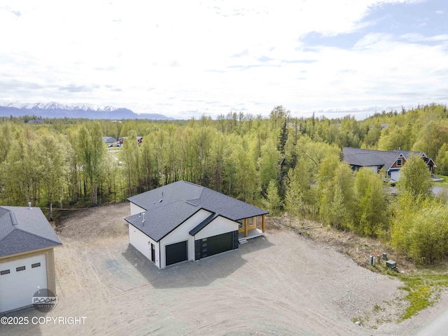 7254 E Riparian Loop, Palmer, AK 99645 - aerial view of property and surrounding area featuring a forest and a mountainous background