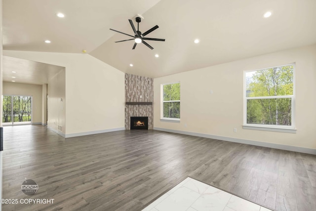 7254 E Riparian Loop, Palmer, AK 99645 - unfurnished living room featuring healthy amount of natural light, lofted ceiling, ceiling fan, recessed lighting, and wood finished floors